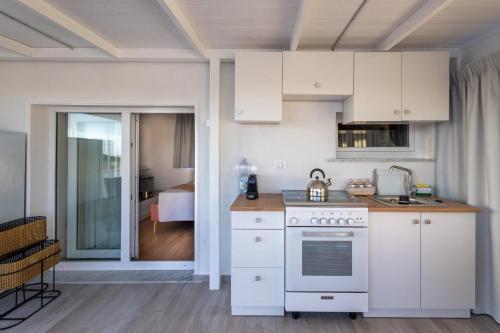 a kitchen with white cabinets and a stove at Maison 31 -Luxury Apartments in Santa Marinella