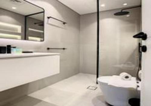 a bathroom with a toilet and a sink and a mirror at Key View - Marina Torch in Dubai