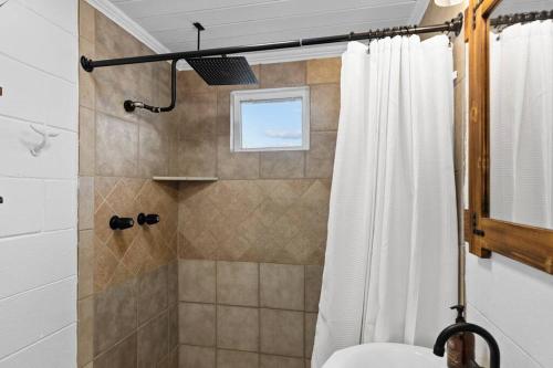 a bathroom with a shower with a shower curtain at Coastal Soul B in Atlantic Beach