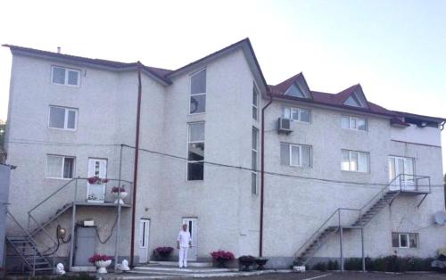 a man standing in front of a large building at Квартира in Chernivtsi