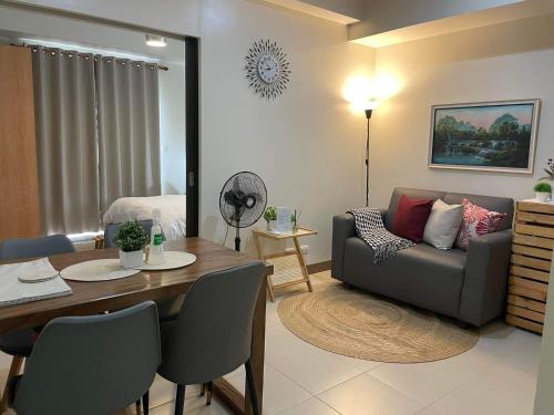 a living room with a couch and a table at 1 Bedroom Condo near ICC Megaworld with netflix in Iloilo City