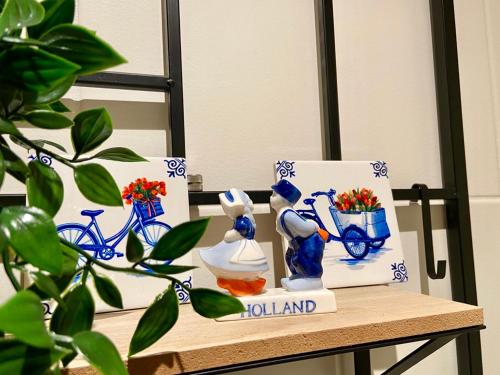 a table with blue and white vases on it at B&B Wellness Soest in Soest