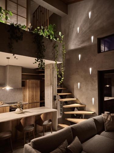 a living room with a couch and a table at Theros Exotica Loft Villa Contemporary 2BR W pool in Tsilivi Hills in Plános