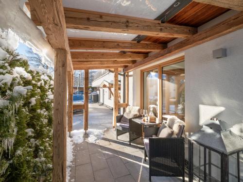 a screened in porch of a house with glass doors at Tirol Chalet Brixen in Brixen im Thale