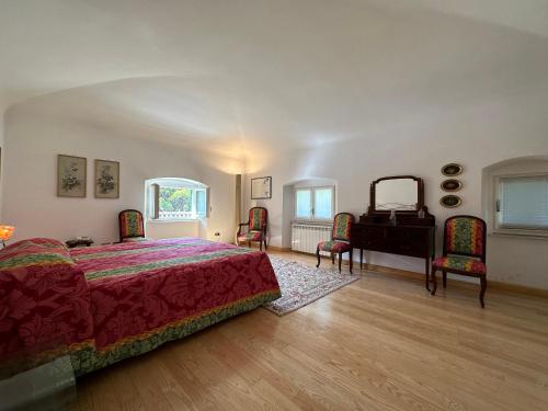a bedroom with a bed and a table and chairs at Villa Doria 16 Pax by VILLASRETREATS in Portovenere