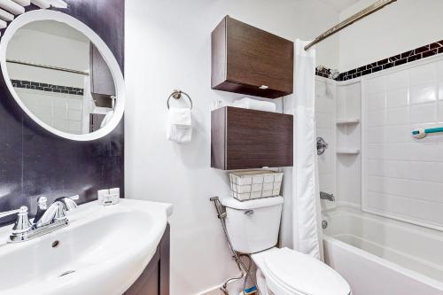 a bathroom with a sink and a toilet and a mirror at The Mountain Sanctuary in Campton