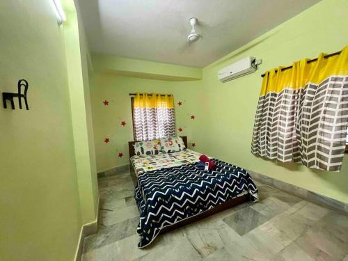 a bedroom with a bed and a window with curtains at Beautiful 2bhk centrally located with free parking in Hyderabad