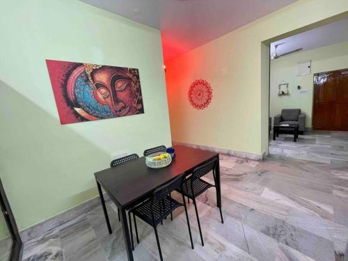 a room with a table and a painting on the wall at Beautiful 2bhk centrally located with free parking in Hyderabad