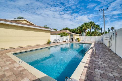 a swimming pool in front of a house at Relax Just Steps to the Soft White Sandy Beach, Heated Pool in Holmes Beach