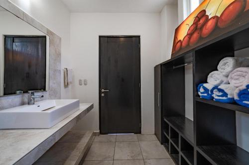 a bathroom with a white sink and a large mirror at 3035 - Chantico 202 in Santa Cruz Huatulco