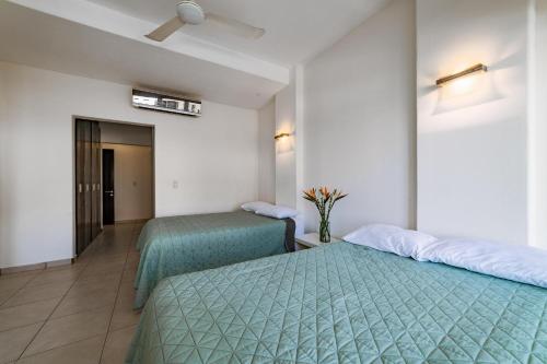 a hotel room with two beds and a hallway at 3035 - Chantico 202 in Santa Cruz Huatulco