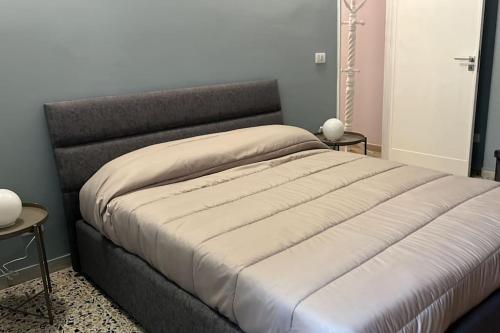 a large bed in a bedroom with two tables at Anna House in Cosenza
