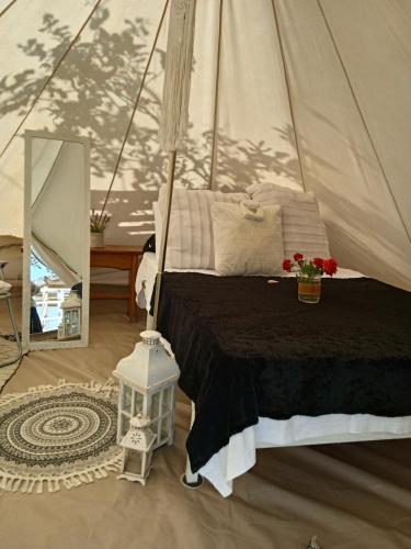 a bedroom with a bed in a tent at Queens Luxury Glamping in Palaiokastro