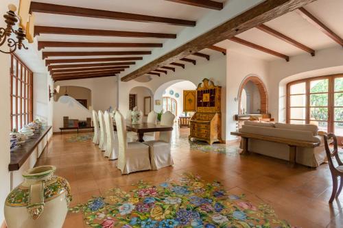 a living room with a table and a dining room at Villa Le Pagine Bianche in Lacco Ameno