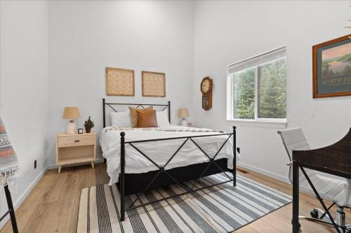 a bedroom with a bed and a window at Beauty Bay Stunner in Coeur d'Alene