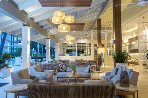 a lobby with couches and tables and chandeliers at Vista Sol Punta Cana Beach Resort & Spa - All Inclusive in Punta Cana