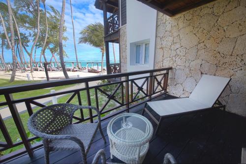 a balcony with a table and chairs and the beach at Vista Sol Punta Cana Beach Resort & Spa - All Inclusive in Punta Cana
