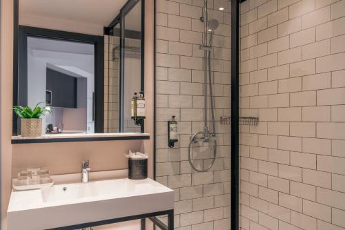 a bathroom with a sink and a shower at Pestana Lisboa Vintage City Center Suites in Lisbon