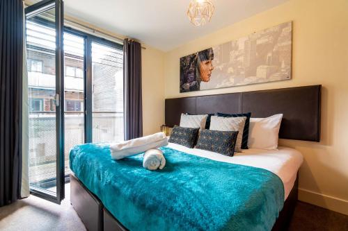 a bedroom with a large bed with a large window at China Town Apartment with Parking 29Arc in Birmingham