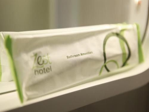 a plastic bag sitting on a shelf in front of a mirror at Zest Airport Jakarta by Swiss-Belhotel International in Tangerang