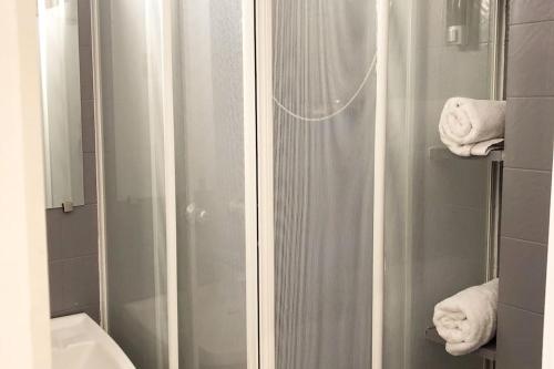 a bathroom with a shower with towels in it at Cozy Studio/ 15min LaDéfense/20min Champs Elysées in Neuilly-sur-Seine