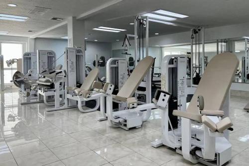 a gym with rows of tread machines in a room at Perfect Family Escape - 3 Bed Condo with Pools in St. George