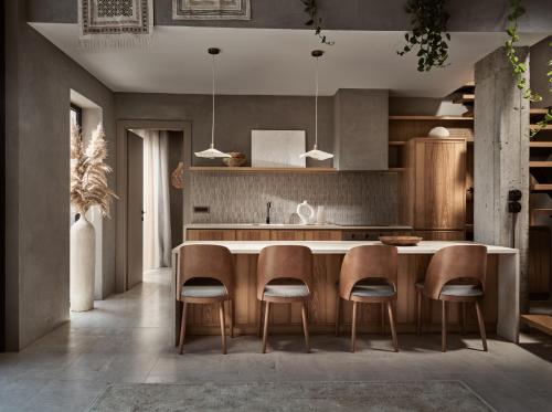 a kitchen with a large island with chairs around it at Theros Exotica Loft Villa Contemporary 2BR W pool in Tsilivi Hills in Plános