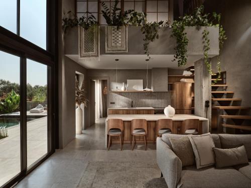 an open kitchen and living room with a table and chairs at Theros Exotica Loft Villa Contemporary 2BR W pool in Tsilivi Hills in Plános