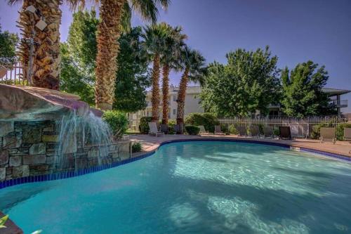a swimming pool with a waterfall in a resort at Perfect Family Escape - 3 Bed Condo with Pools in St. George