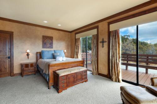 a bedroom with a bed and a balcony at Catamount Lodge in Ridgway