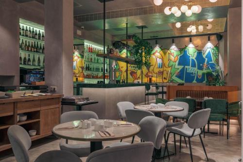 a restaurant with tables and chairs and a bar at Pestana Lisboa Vintage City Center Suites in Lisbon