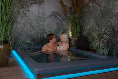 a man and a woman sitting in a bath tub at Hotel Locanda Al Piave ***S in San Donà di Piave