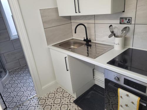 a small kitchen with a sink and a counter at Beautiful 1-Bed Apartment in Ramsgate in Ramsgate