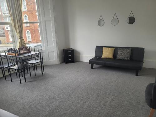 a living room with a couch and a table at Beautiful 1-Bed Apartment in Ramsgate in Ramsgate