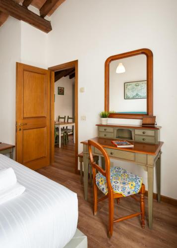 a bedroom with a desk with a mirror and a bed at Era Rental Apartments in Florence