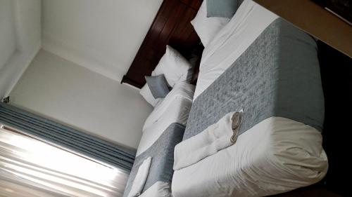 a large bed in a room with a window at Twiga Whitehouse Villas in Nakuru