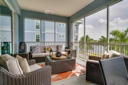 un porche cubierto con sillas y un sofá en Gorgeous condo with luxurious amenities and lagoon views, en Bradenton