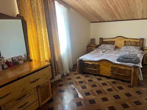 a bedroom with a bed and a dresser and a television at Ashtarak Nor Tun in Ashtarak
