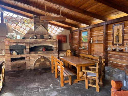 a dining room with a wooden table and a fireplace at Ashtarak Nor Tun in Ashtarak