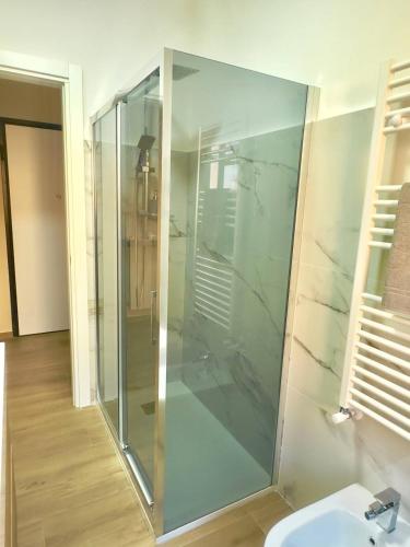 a glass shower in a bathroom with a sink at Casa Luciana Apartment in San Giovanni Rotondo