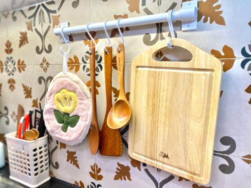 a group of wooden utensils hanging on a wall at G-space apartment in Hai Phong