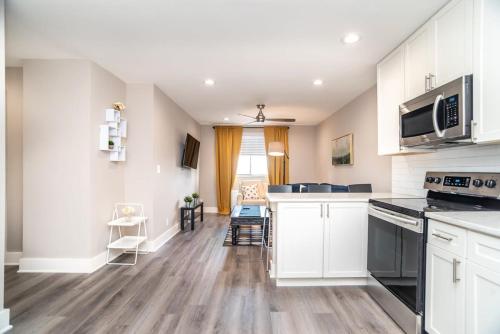a kitchen with white cabinets and black appliances at Close to everything fun Free Parking LM1704 in Atlanta