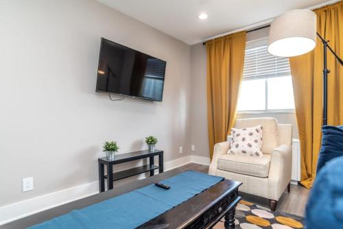 a living room with a couch and a tv on the wall at Close to everything fun Free Parking LM1704 in Atlanta