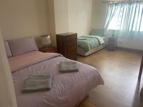a bedroom with a bed with two towels on it at Kickham Street Budget Accommodation in Carrick-on-Suir