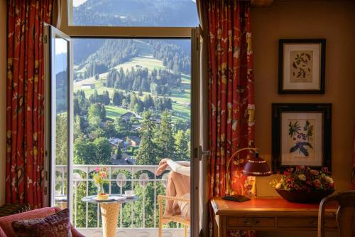 a room with a window with a view of a mountain at Gstaad Palace in Gstaad