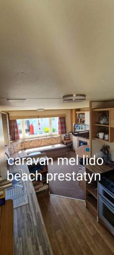 a kitchen with a large window in a room at Lido beach prestatyn in Prestatyn