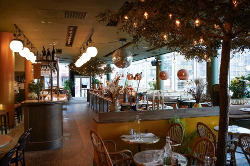 a restaurant with tables and chairs and a bar at Comfort Hotel Winn in Umeå