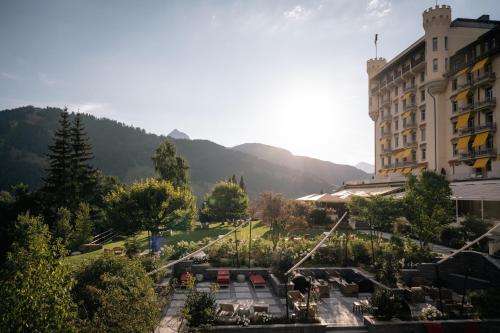 a hotel with a view of a park and a building at Gstaad Palace in Gstaad