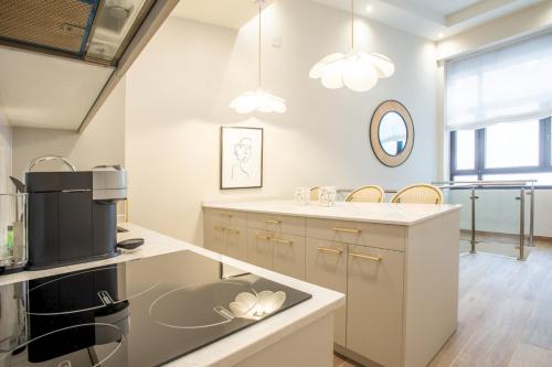 a kitchen with a sink and a microwave at 2 bedrooms 2bathrooms furnished - Chamberi - refurbished - MintyStay in Madrid