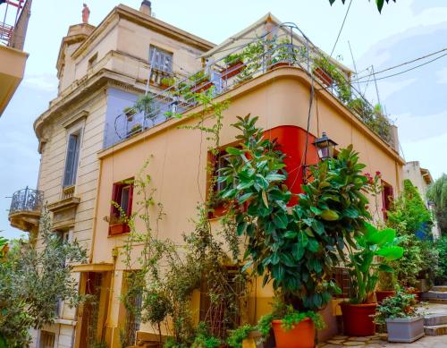 a house with plants in front of it at The Acropolis House of Flowers~Private Roof Garden in Athens